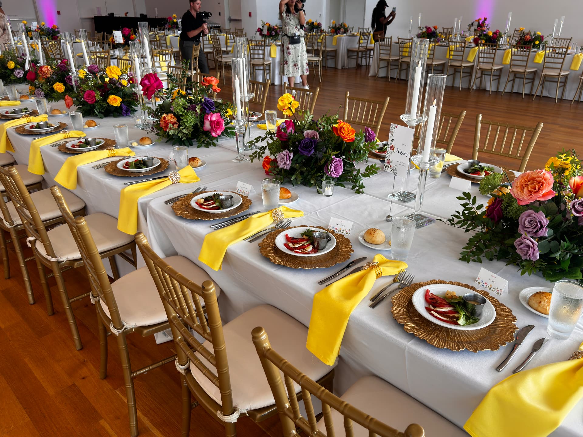 Banquet tables set with gold chargers, tall tapers and low florals — Weddings by Good Time Mascots in Columbus, Ohio