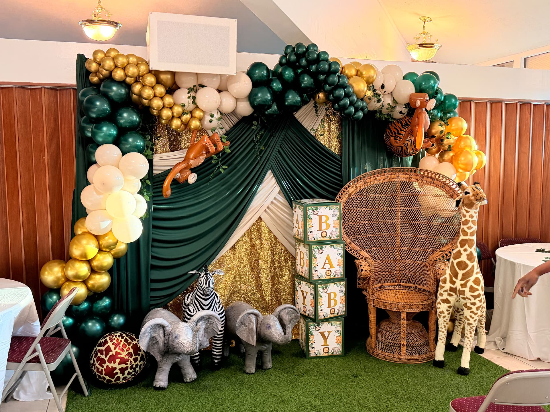 Emerald & gold safari arch framing a baby shower photo station — Balloon Décor by Good Time Mascots in Columbus, Ohio