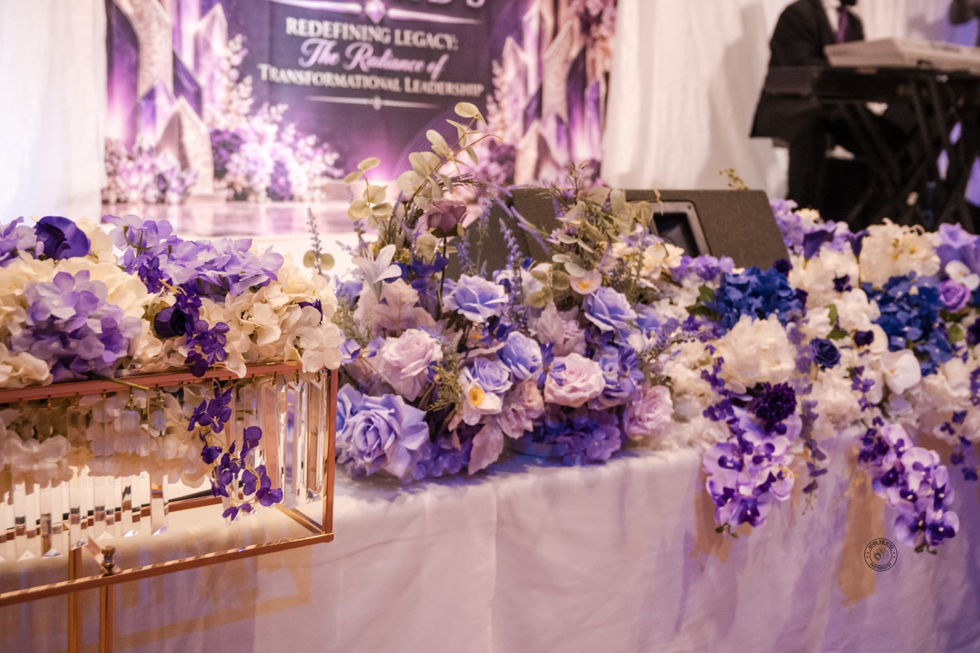 Floral head-table installation with gold stands & stage backdrop — Corporate & Brand Experiences by Good Time Mascots in Columbus, Ohio