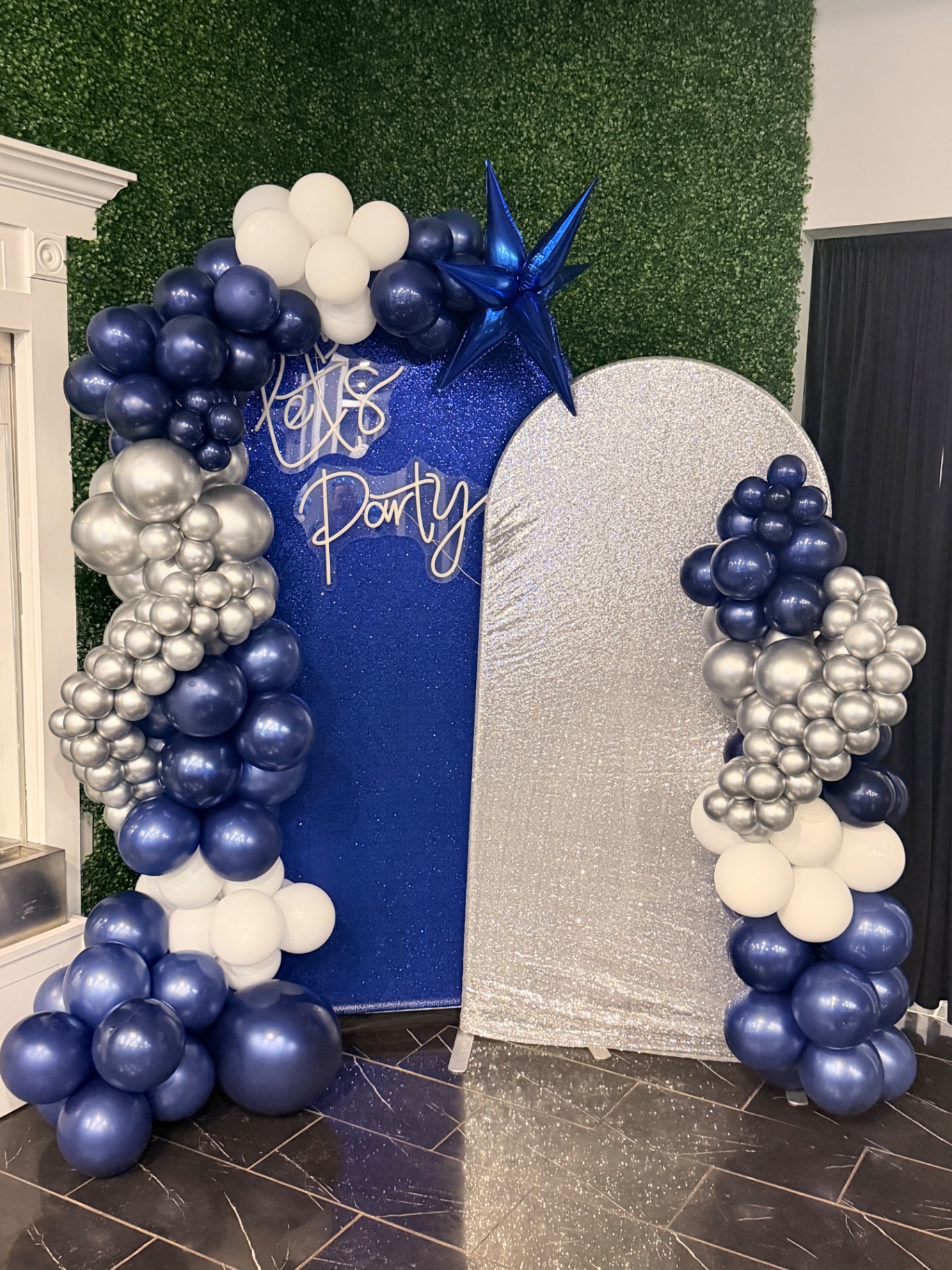 Organic garland framing a neon photo backdrop — Balloon Décor by Good Time Mascots in Columbus, Ohio
