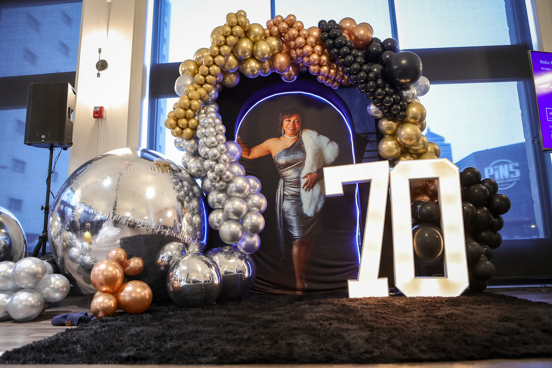 Balloon arch over a milestone photo op with lit marquee numbers — Balloon Décor by Good Time Mascots in Columbus, Ohio