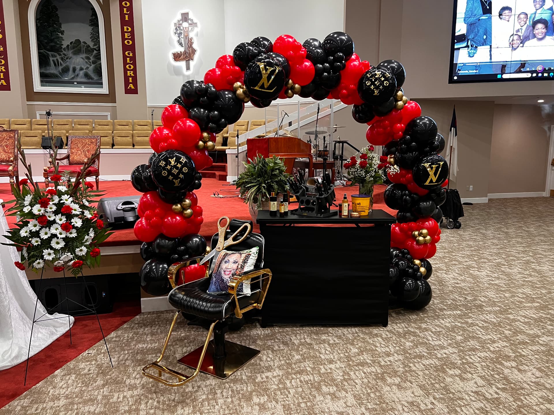 Personal tribute station with a stylist chair and keepsakes beneath a balloon arch — Celebration of Life & Memorials by Good Time Mascots in Columbus, Ohio