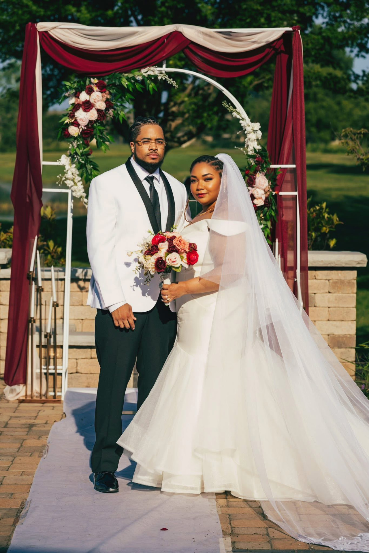 Bride and groom beneath a burgundy-draped arbor — Weddings by Good Time Mascots in Columbus, Ohio